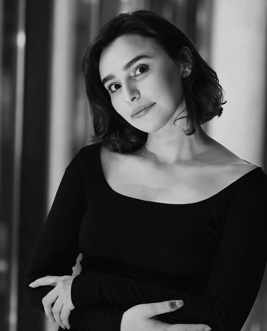 Portrait of a woman in black against soft window light